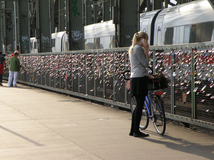 Una ciclista ante los millares de candados del puente Hohenzollern